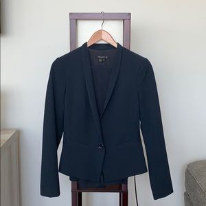 Woman’s navy blue business suit by Femme